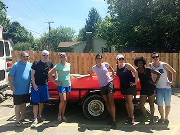 Marketing team posing in front of kayak trailer